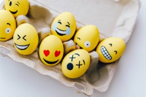Cartoon full of yellow eggs with emoji faces